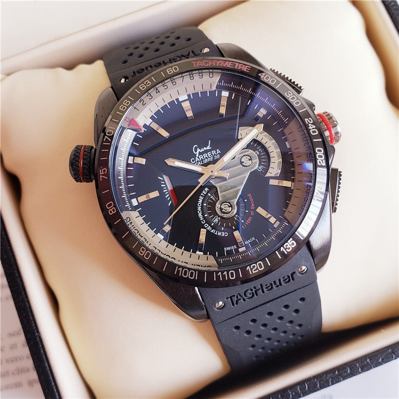 Close-up of a TAG Heuer mechanical watch featuring a sleek design and black rubber strap.